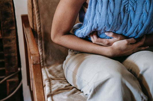 woman experiencing indigestion holds her stomach